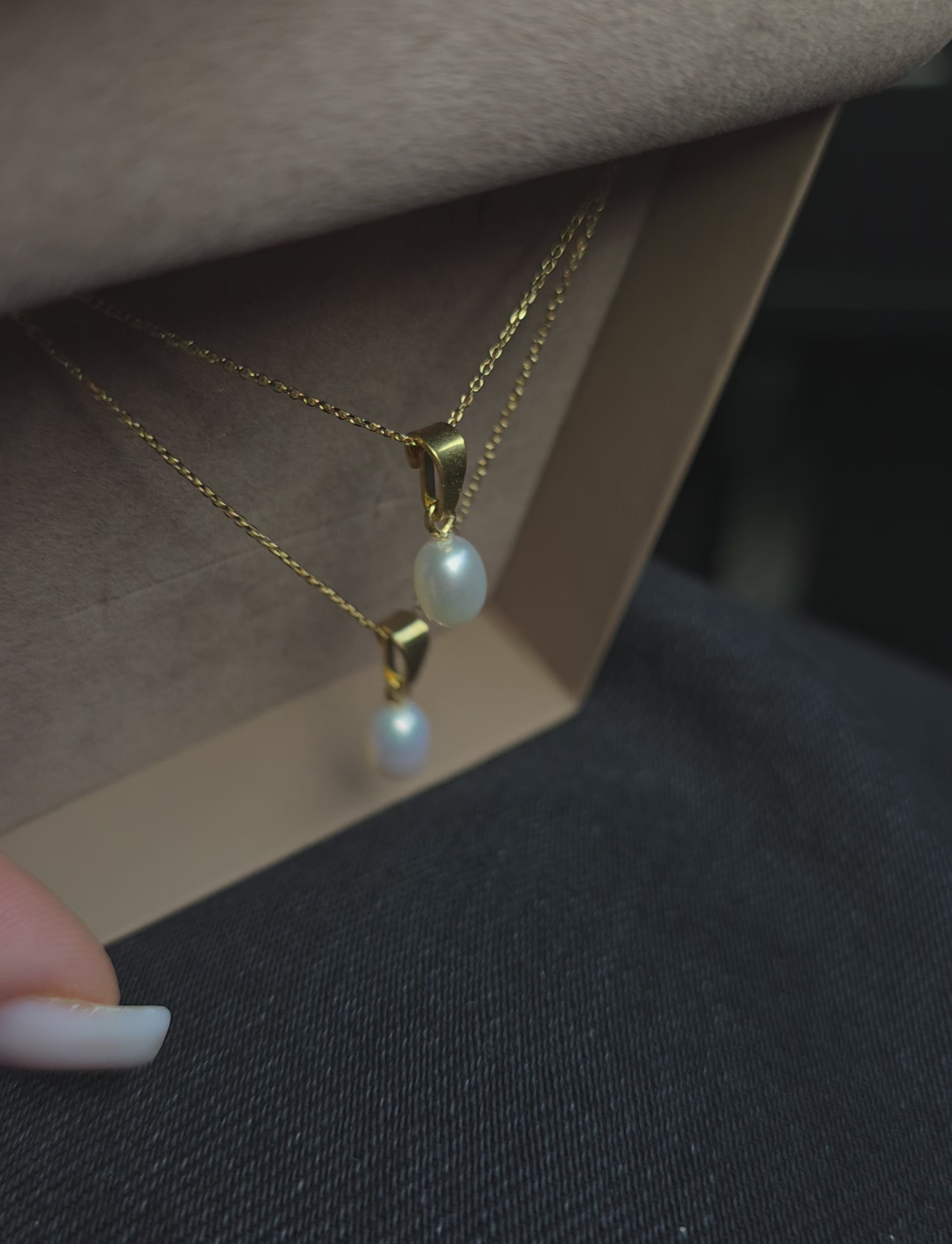 Gold‑plated silver necklace with an oval freshwater pearl pendant photographed on a clean, minimal background.