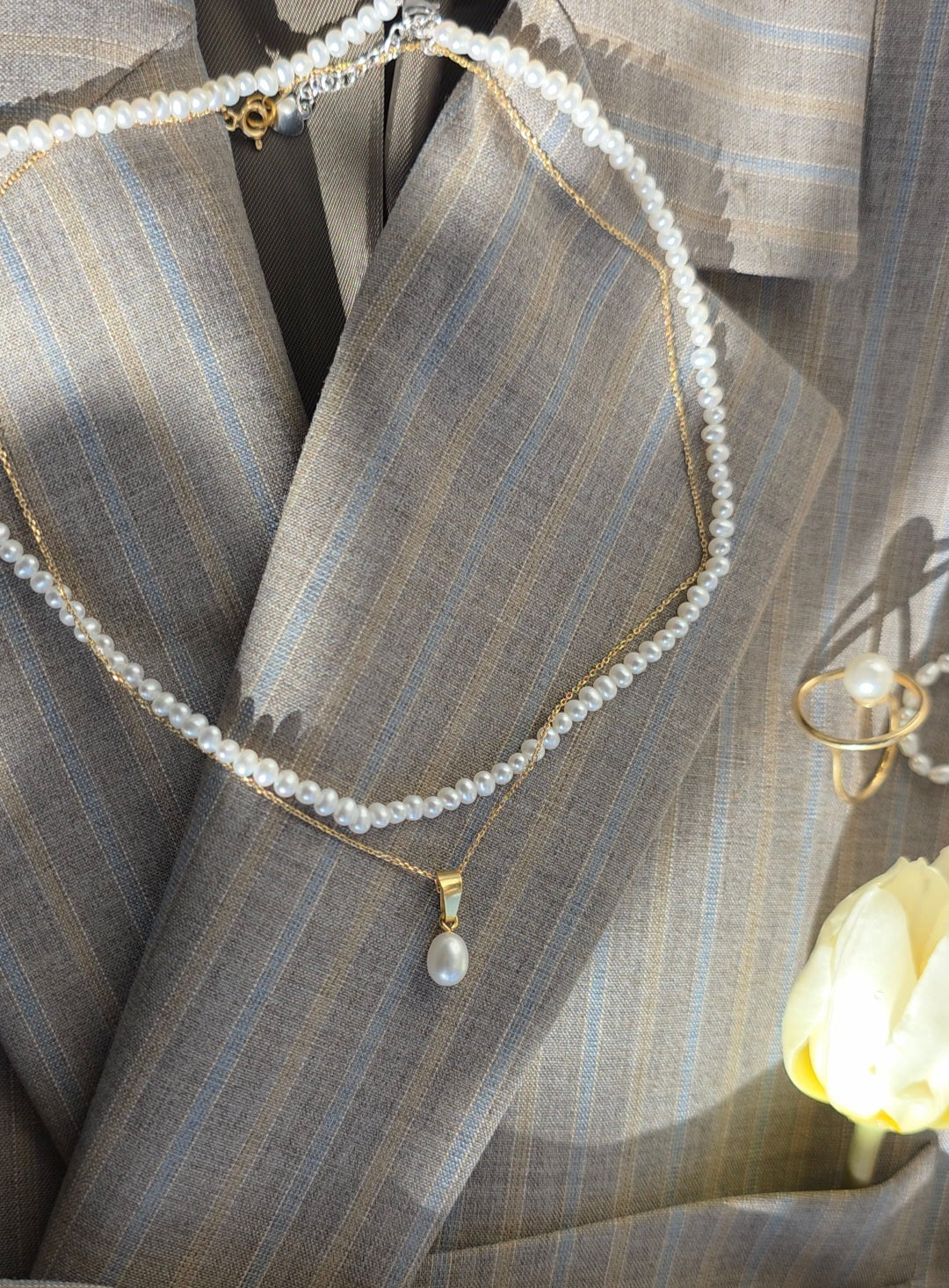 Pearl necklace on a striped fabric background