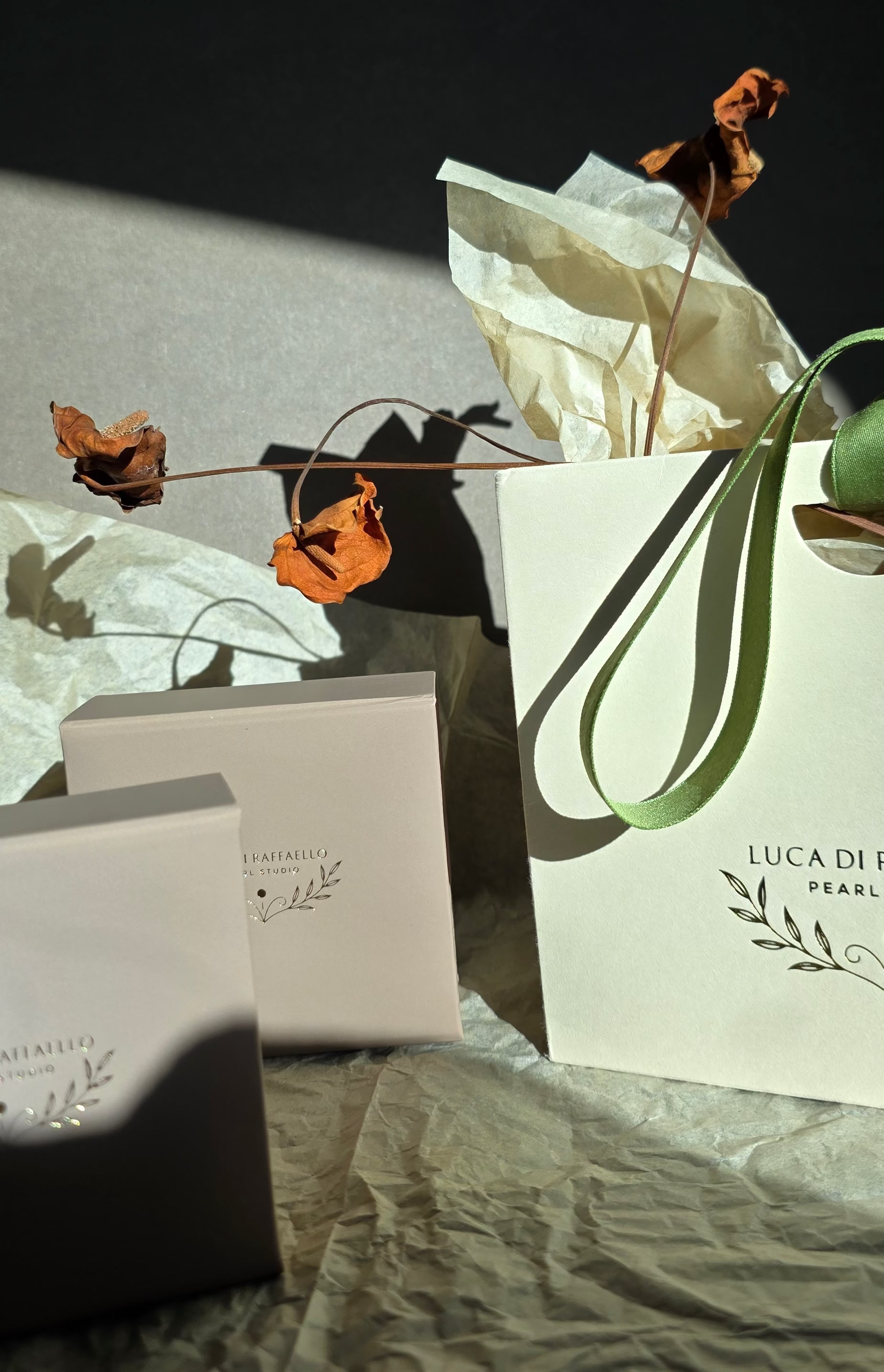 Luxury product packaging with dried flowers on a textured surface